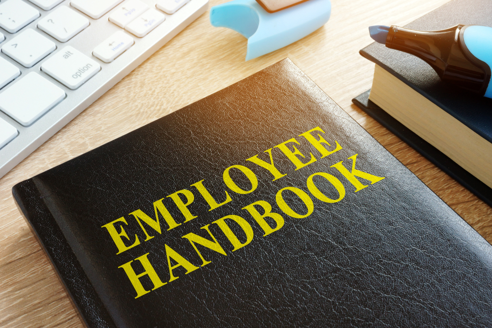 employee handbook on a wooden desk
