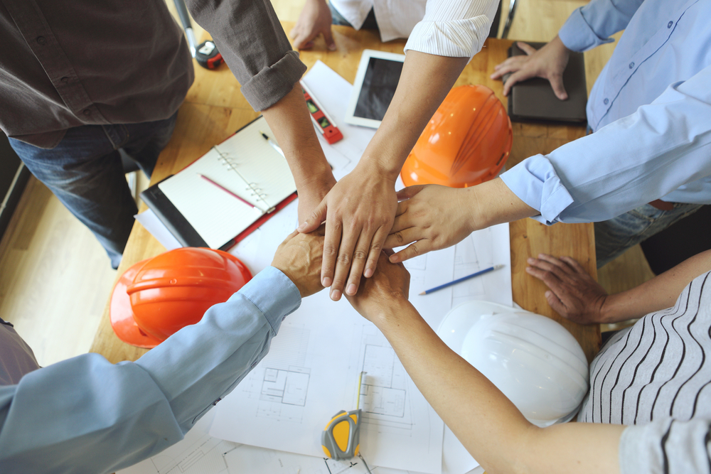 work group of engineer people joining hands